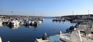 A marina with multiple boats docked, calm water, and a clear sky. - Pretty house in Taviano, a stone's throw from Gallipoli. (Taviano)
