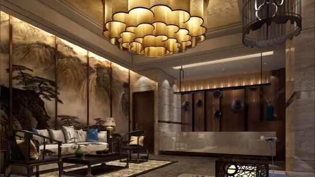 A modern lobby with a large, ornate chandelier, a sofa set, and a decorative wall with a waterfall mural. - Zhengda International Hotel (Jiangling)