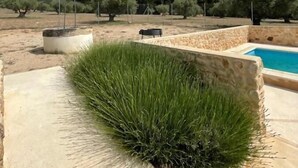A landscaped area with a pool, stone walls, and olive trees. - Rural house among olive trees (Biar)