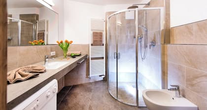 5 minutes from the Alpe di Siusi cable car, family apartment and terrace.