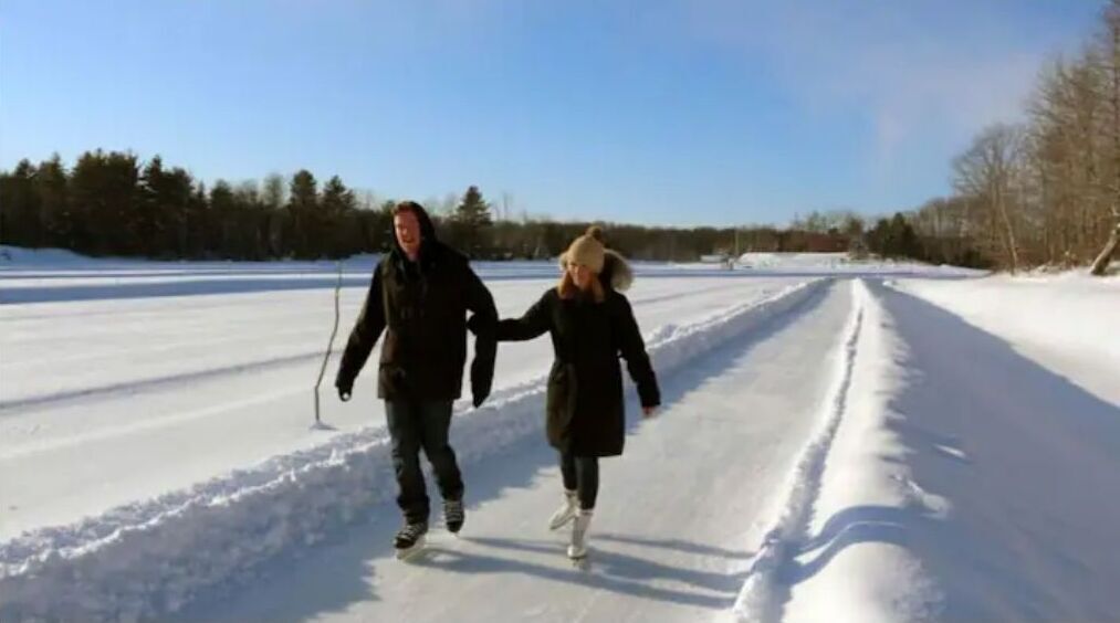 A couple walking on a snow-covered path.