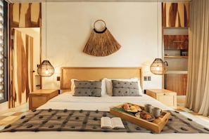 A neatly arranged hotel room with a bed, bedside lamps, a tray with food and drinks, and a book on the bed. - NAJ Boutique Hotel-Aldea Zama (Tulum)