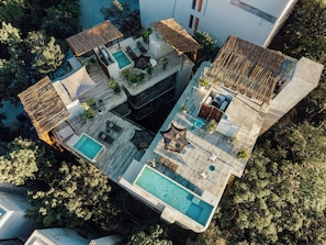 An aerial view of a modern house with a swimming pool, outdoor seating, and a garden. - NAJ Boutique Hotel-Aldea Zama (Tulum)