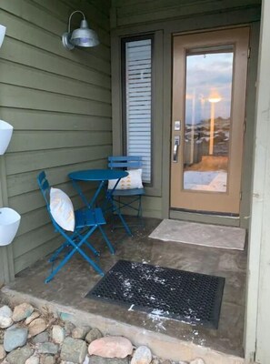Relax in this serene outdoor space with a table and chairs, perfect for casual gatherings.
