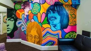 A vibrant mural with abstract patterns and faces. - Beatles Themed Hotel (Liverpool)