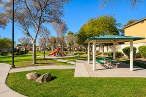 A park with a playground, picnic tables, and a covered seating area. - Pet-Friendly 3BR | Fenced Yard | King Bed (Chandler)