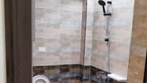 A modern bathroom with a bathtub, a shower, and a toilet.