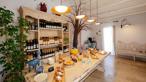 A buffet setup with a variety of food items and a wine selection.