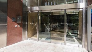 A modern building entrance with glass doors and a metal frame. - Bourbon Street Bliss (New Orleans)