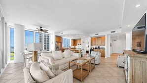 A spacious living area with a sofa set, coffee table, and a television. - Stunning Lagoon Front Views | Pool | Fishing Pier & Boat Slips (Gulf Shores)