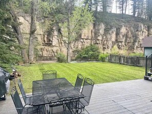 Enjoy al fresco dining on the patio overlooking the rocky cliff face.