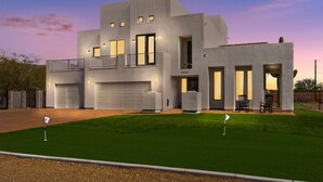 A modern two-story house with a garage, a balcony, and a well-maintained lawn. - 1+ Acre 5 Bedroom Desert Oasis with Pool and Mountain Views! (Apache Junction)