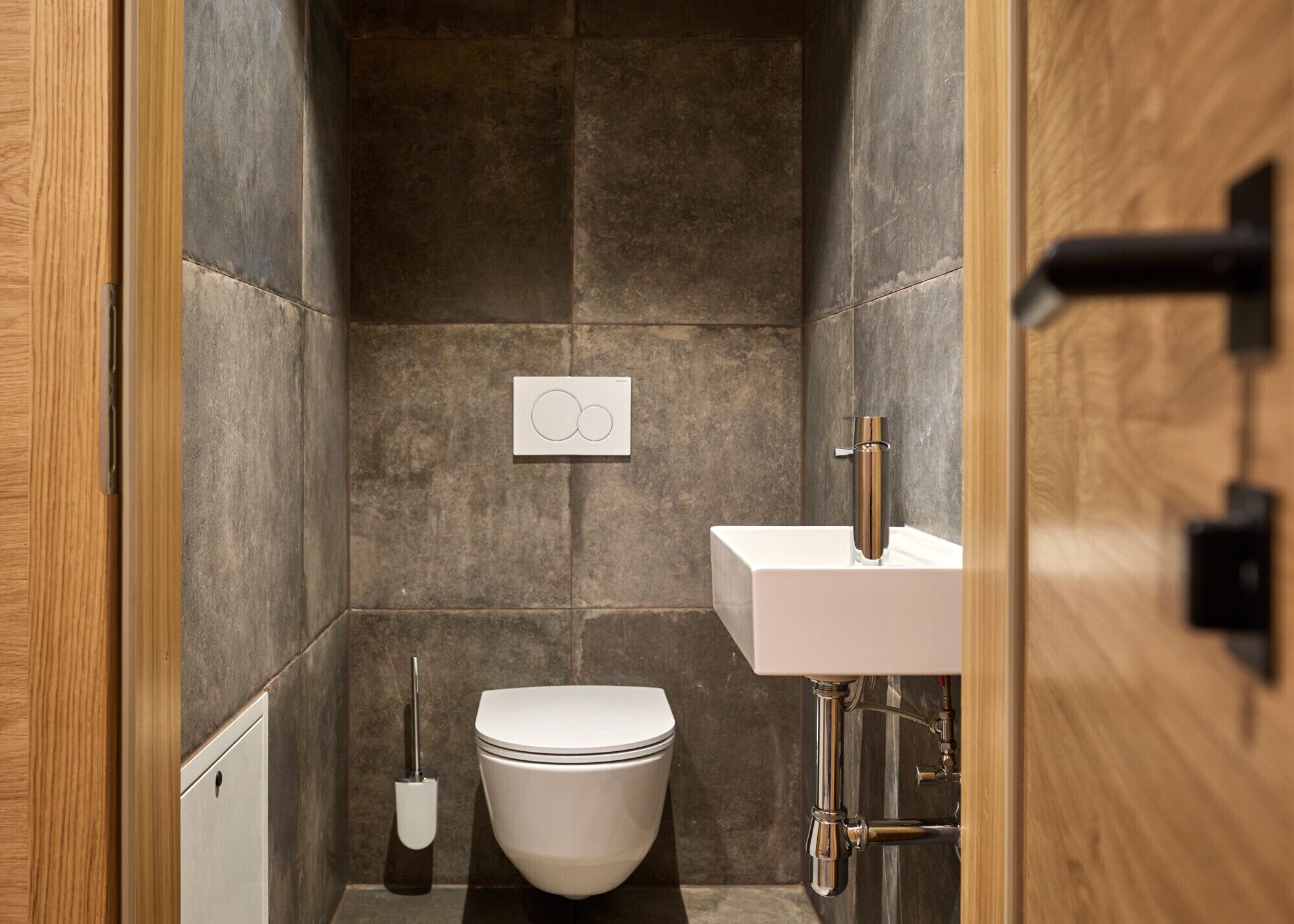 A modern bathroom with a toilet, sink, and shower.