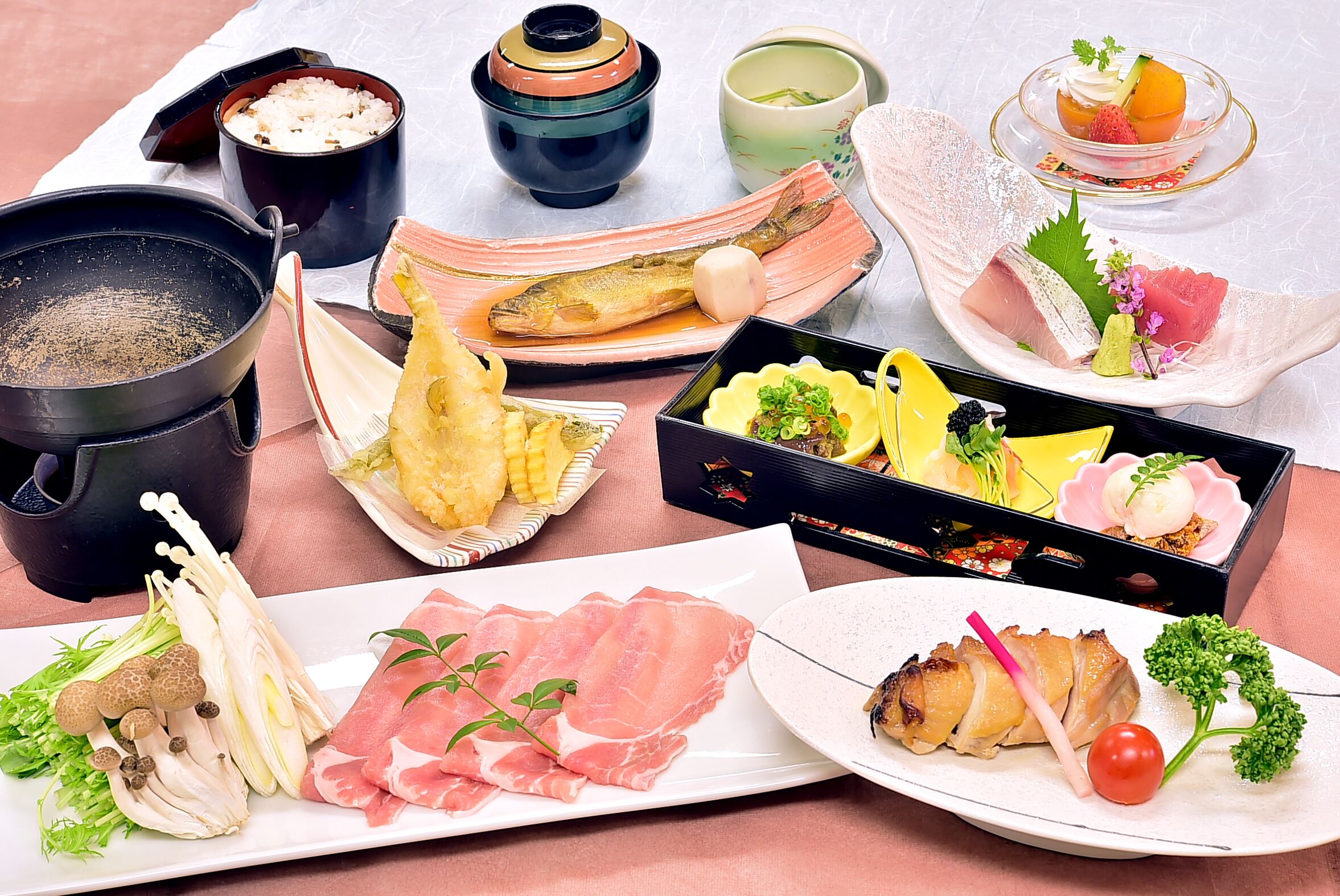 A variety of dishes and food items on a table, including a pot, bowls, and plates with different types of food.
