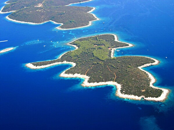An aerial view of a series of islands with clear blue waters and white sandy beaches.