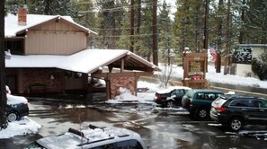 Guests can enjoy a covered porch and parking area at this two-story lodge.