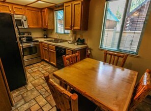 Enjoy cooking in this well-equipped kitchen with a central island, refrigerator, microwave, oven, and dishwasher.