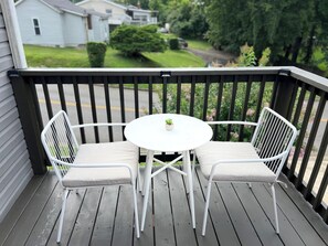 Enjoy a peaceful outdoor space with a deck featuring a table and two chairs.