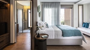 A modern bedroom with a bed, bedside table, and a view of the city. - Salina SPA Villas - with PRIVATE ECO-POOL, SAUNA & Hot Tub (Volos)