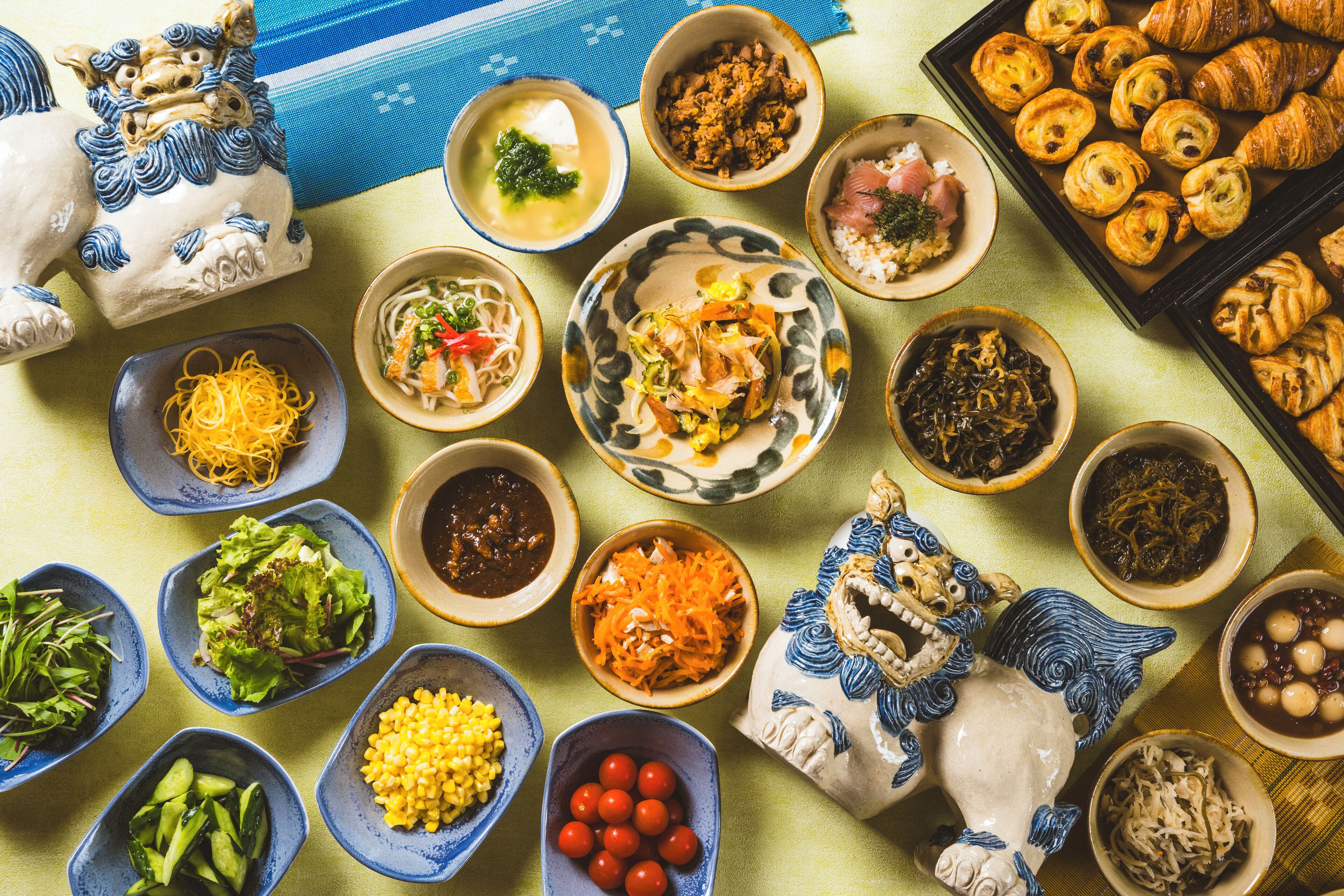 A variety of dishes and food items arranged on a table.