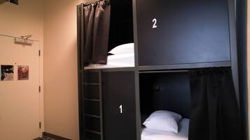 A bunk bed room with two beds, numbered 1 and 2, and a ladder for access.