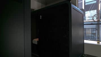 A room with a large window, a black partition, and a visible number '2' on the wall.