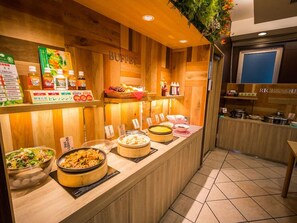 Un área de bufé con diversos alimentos y salsas.