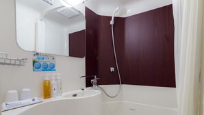 Un baño moderno con inodoro, lavamanos y ducha.