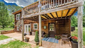 A wooden cabin with a covered porch, satellite dish, and outdoor seating area. - Tatum’s Retreat -SAUNA- Hiking-Wineries- Unit B (Madison)