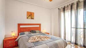 A bedroom with a bed, nightstands, a painting, and a window with curtains. - Beautiful home in Ciudad Quesada (Ciudad Quesada)
