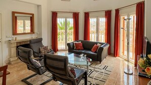 A living room with a fireplace, a sofa, a coffee table, and a TV. - Beautiful home in Ciudad Quesada (Ciudad Quesada)