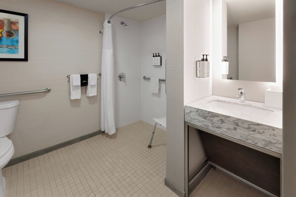 A modern bathroom with a shower, toilet, and sink. - Crowne Plaza Nashville Airport by IHG (Nashville)