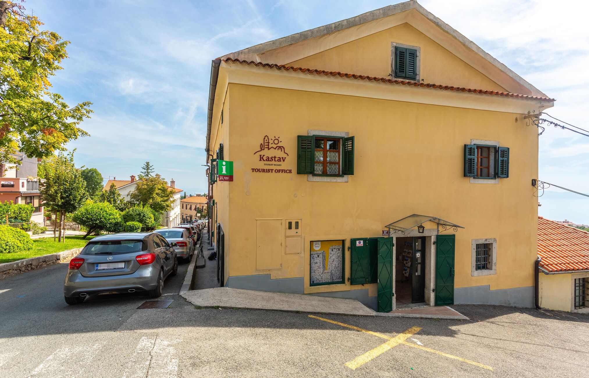 A yellow building with a sign for the Kastav Tourist Office.