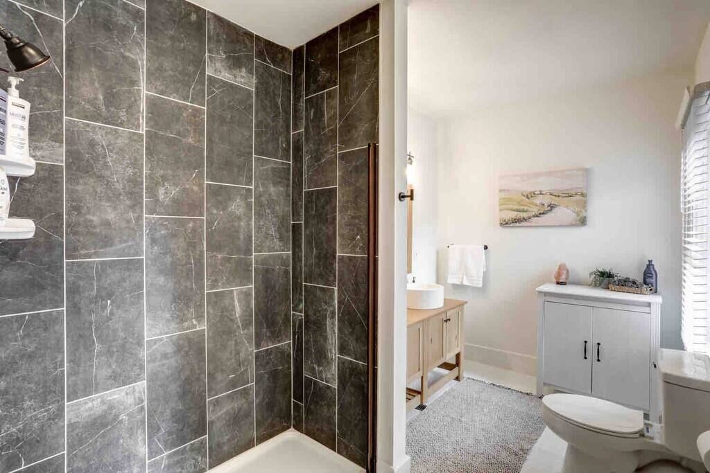 Bathtub, hair dryer, slippers, towels