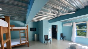 A room with bunk beds, a desk, a chair, a TV, and a window with a view. - this place will bring lots of peace to enjoy the sun and the beach! (San Antero)
