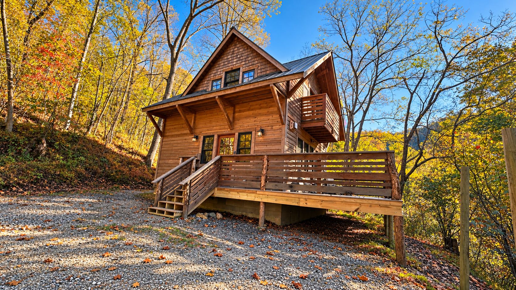 A wooden cabin with a porch and a staircase leading to the entrance.