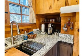 The workstation sink with cutting board and drying racks & the espresso machine