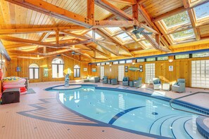An indoor swimming pool with wooden beams and large windows. - Vermilion River Home w/ Hot Tub & Private Dock! (Vermilion)