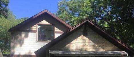 A two-story house with a front porch and a garage.