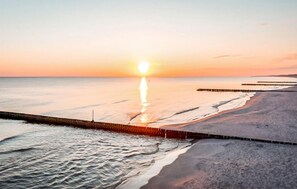 A beach with a wooden pier extending into the water. - Nice home in Nowecin with WiFi (Nowecin)