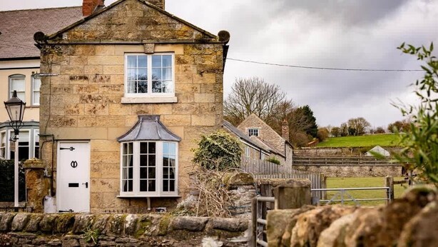A stone house with a white door and a window with a white frame. - Yew Tree Cottage | Farm Stay | Sleeps 4 (West Ayton)