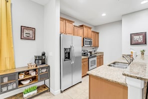 Enjoy cooking in this well-equipped kitchen with a gas stove, microwave, and sink.