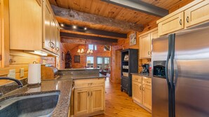 Eine moderne Küche mit Holzschränken, Granit-Arbeitsplatten und Edelstahlgeräten.