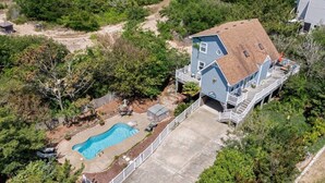 A two-story house with a swimming pool, surrounded by dense greenery. - Secluded 3min Walk to Beach! Private Pool & Spa (Corolla)