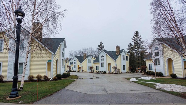 A residential street with houses, a street lamp, and a sidewalk. - Birch Grove Cottage, Downtown Fish Creek (Fish Creek)