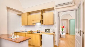 A modern kitchen with wooden cabinets, a built-in microwave, and a dishwasher. - Goccia Di Mare 50m From The Sea, Alassio, Italy (Alassio)