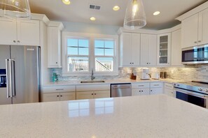 Fridge, microwave, oven, stovetop - Luxury Kure Beach Getaway | Steps to Beach, Ocean Views, Elevator, Grill + Games (Kure Beach)