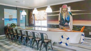 A reception area with a counter, chairs, and artwork.