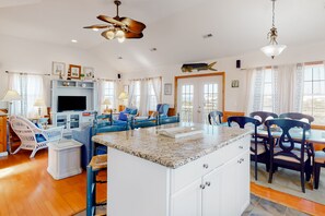 Relax in this inviting living area with a central island, comfortable seating, and a large television.