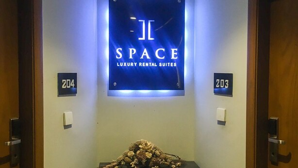 A hallway with a sign for 'Space Luxury Rental Suites' and room numbers 204 and 203. - Space Suites (Rawalpindi)